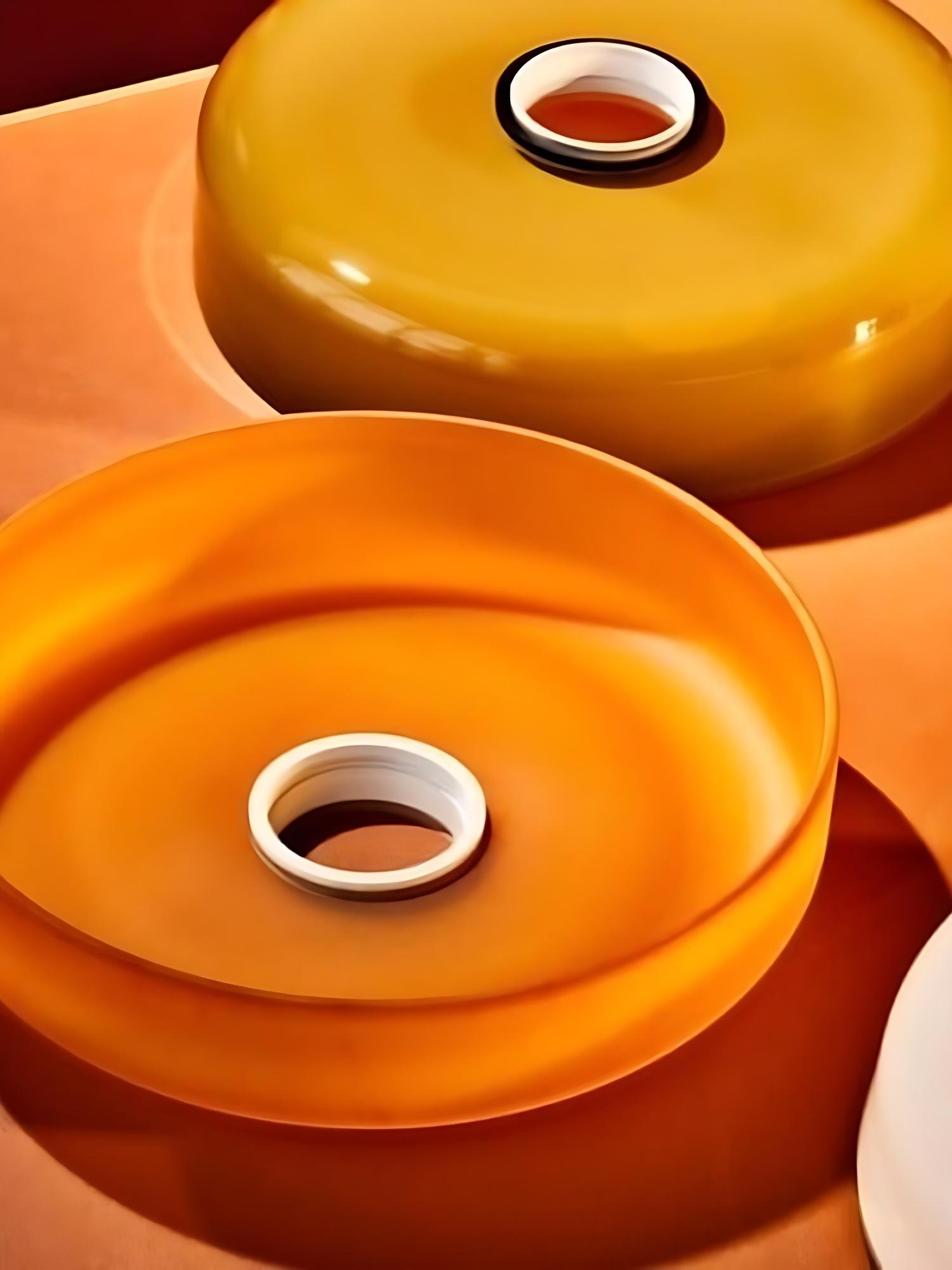 Thick olive and orange glass discs with a white centre ring