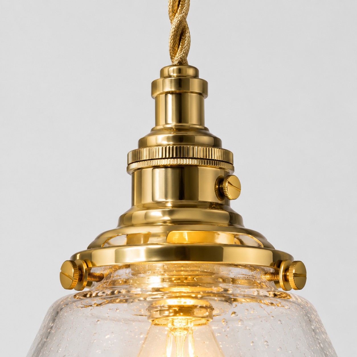 Warm brass-toned pendant hardware close-up