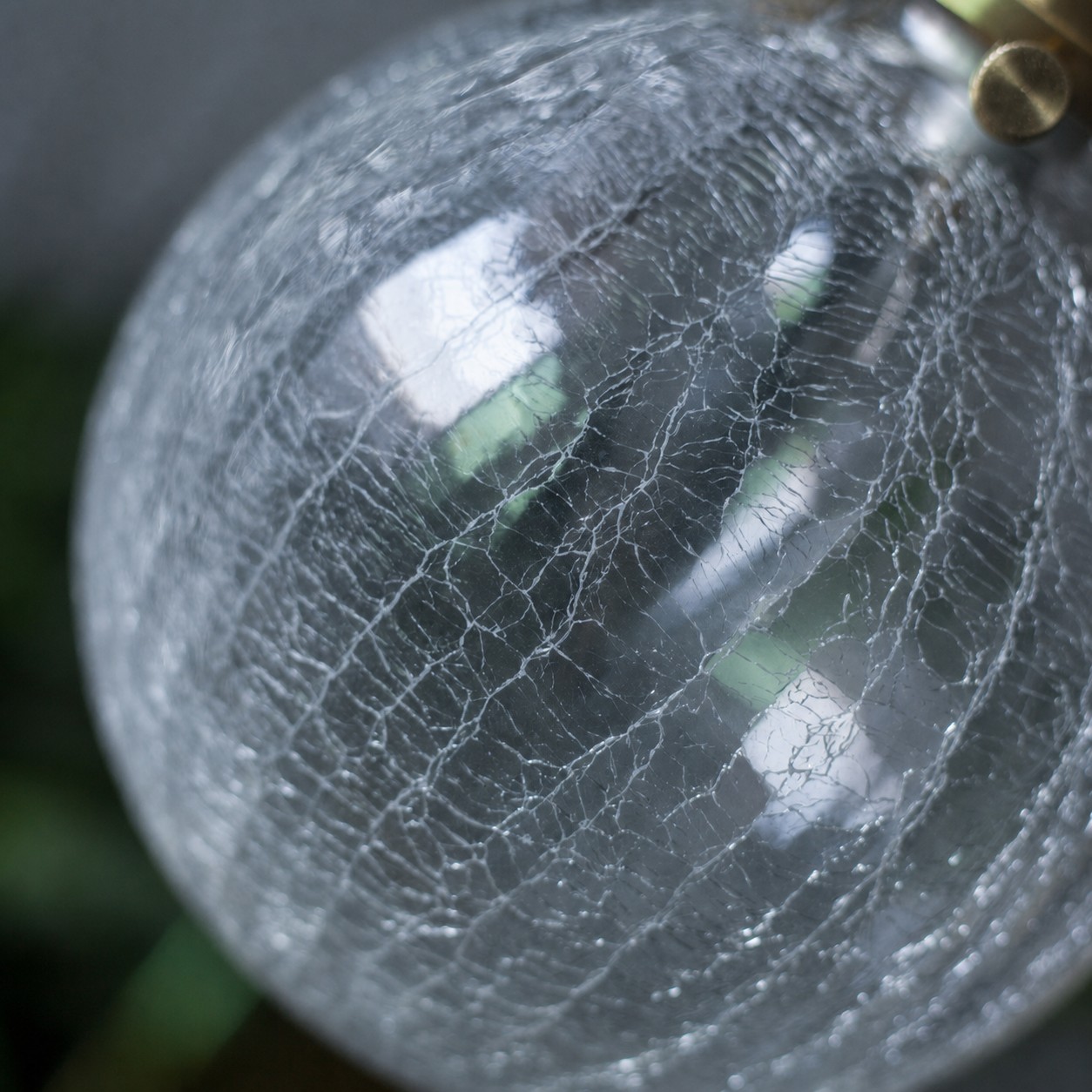 Close-up of ice-crackle texture on the clear glass globe shade
