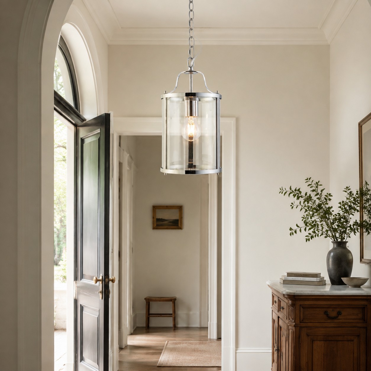 Polished silver clear-glass lantern pendant in an entryway