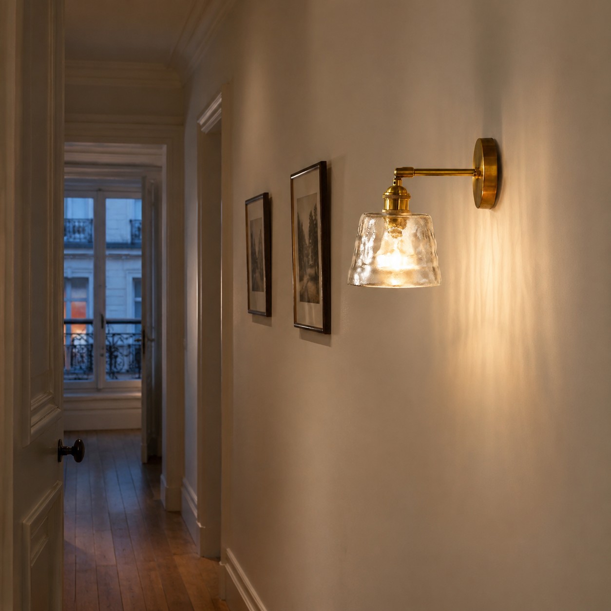 Compact brass rippled glass wall sconce lighting a narrow hallway
