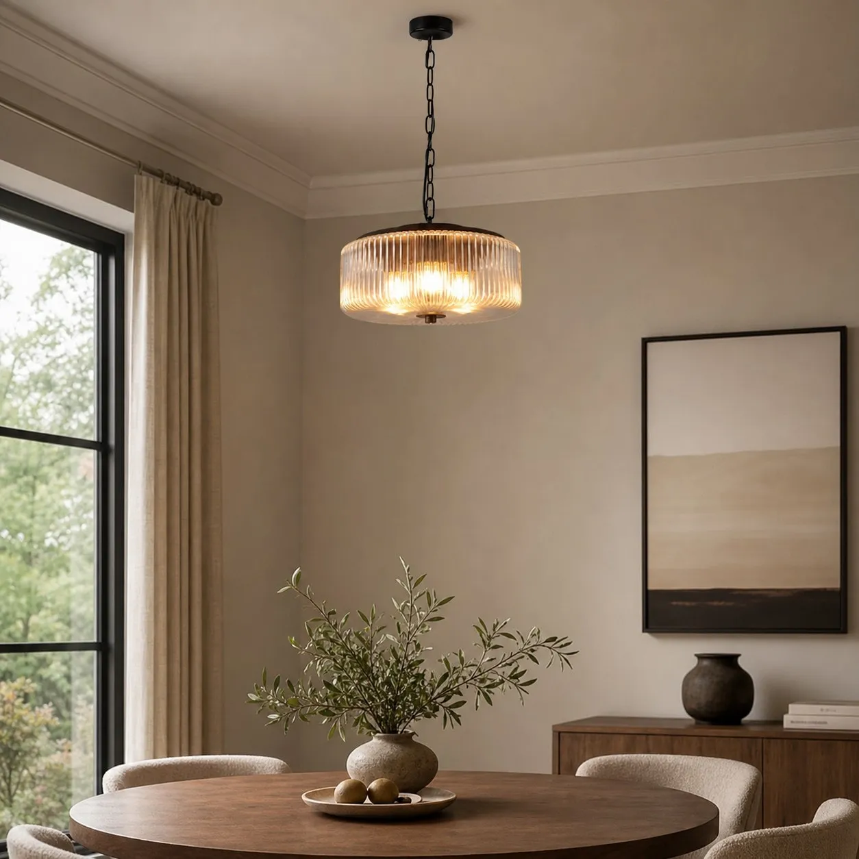 Black ribbed glass pendant ceiling lamp above a dining table