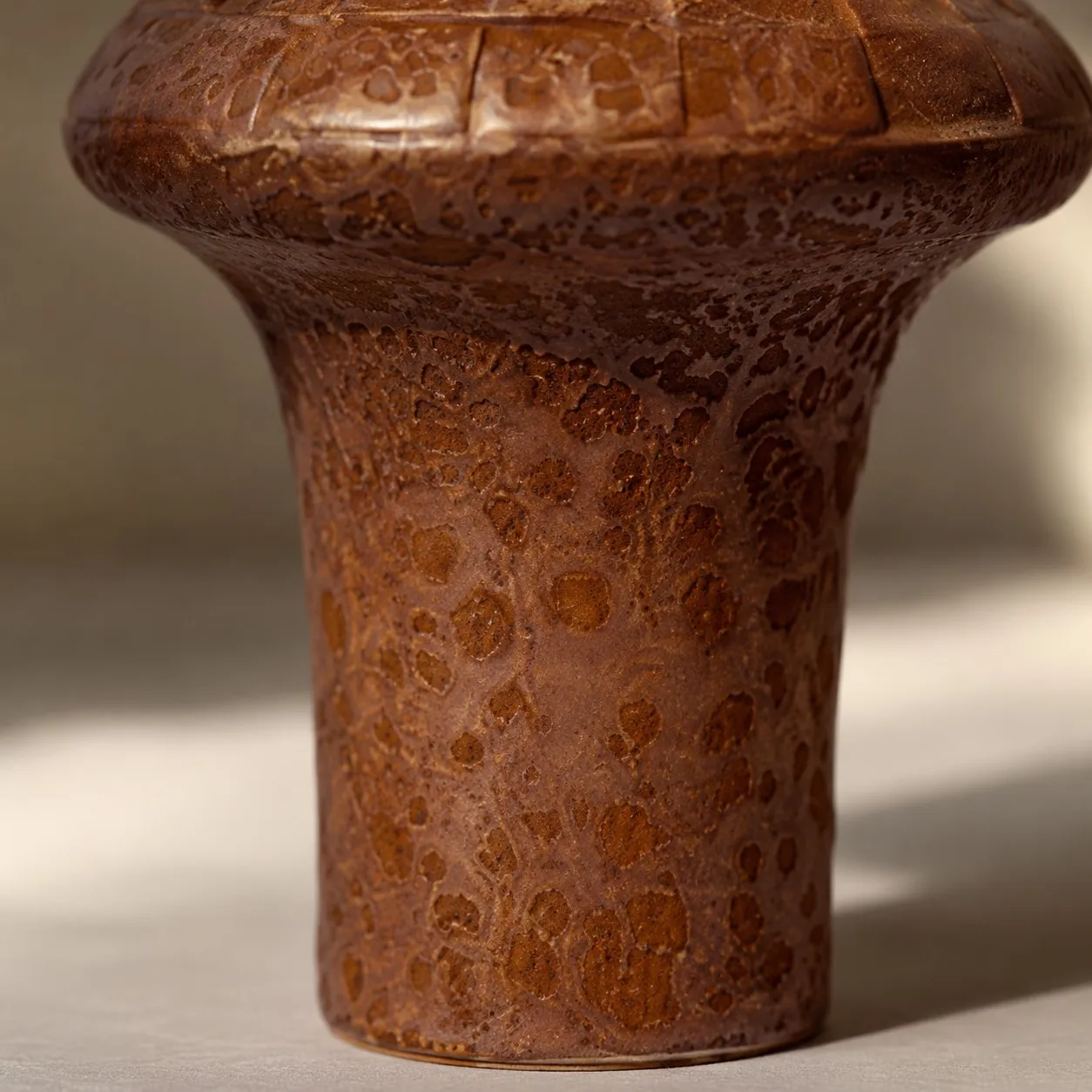 Close view of warm brown ceramic lamp base texture