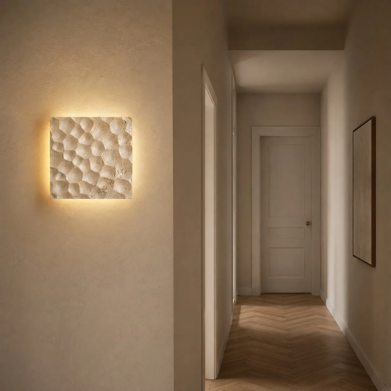 Ivory carved travertine wall sconce in French apartment hallway