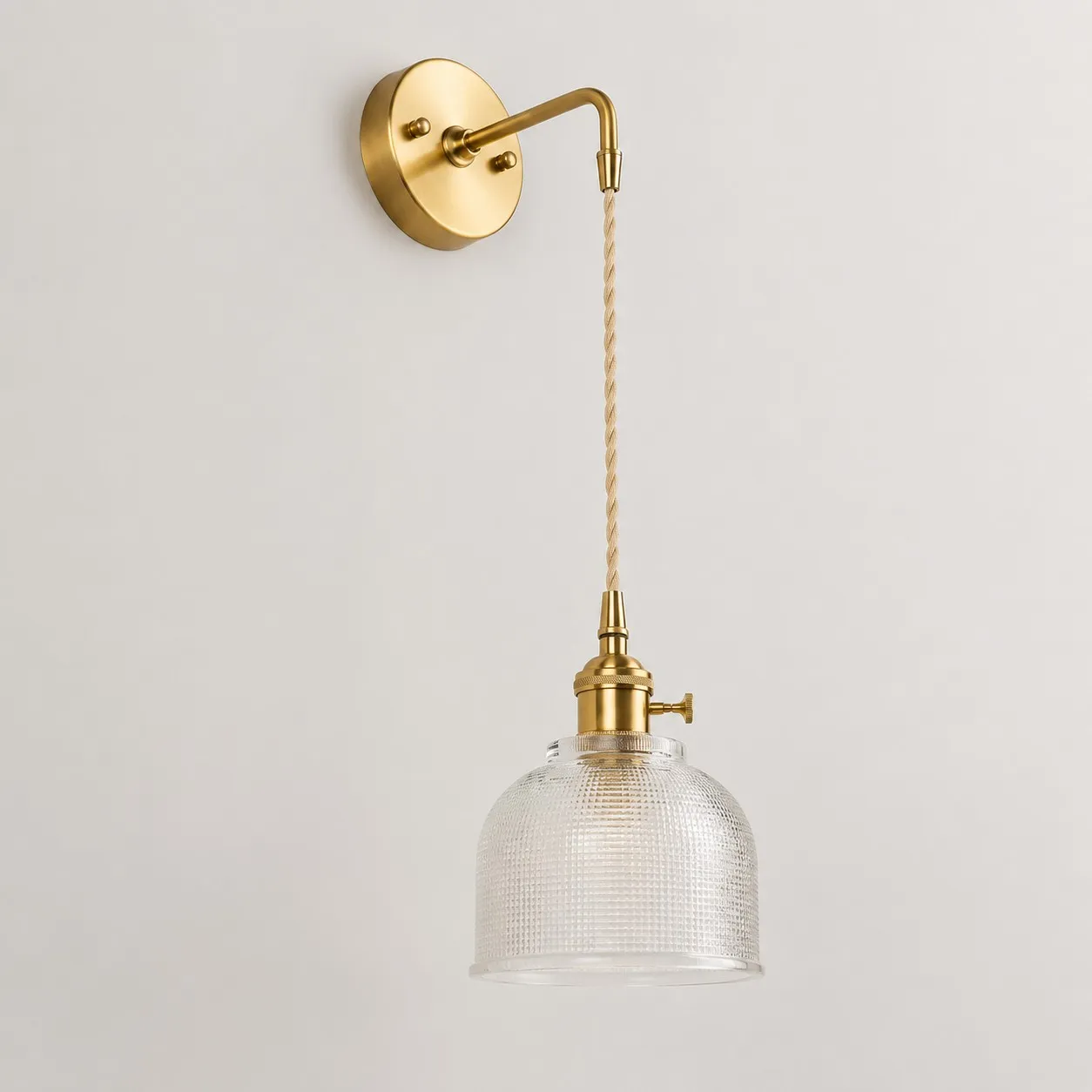 Clear glass wall light with brass arm, CW shade 11 cm high and 14 cm diameter