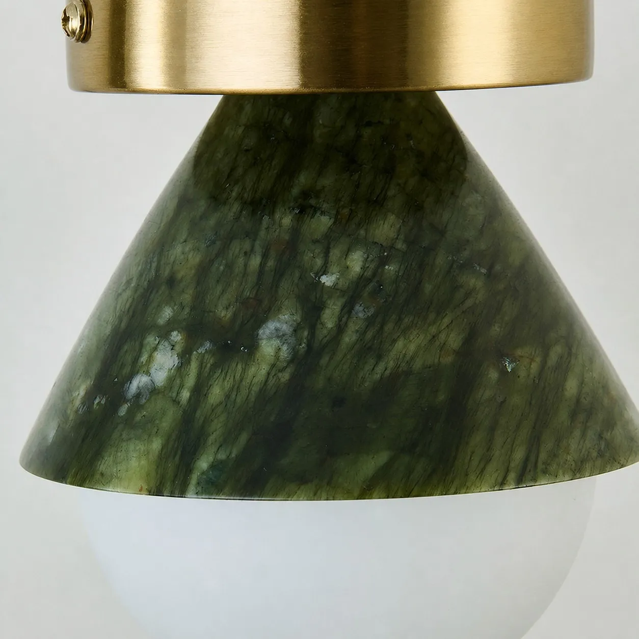 Close-up of green jade-style shade and brushed metal canopy