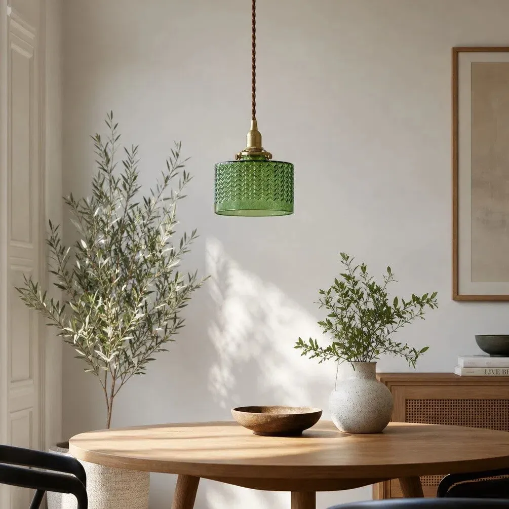 Emerald glass pendant above a dining table