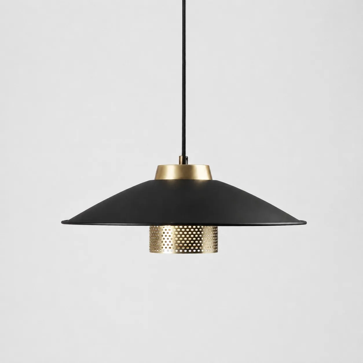 Black and antique brass metal pendant light with wide conical shade on a white background
