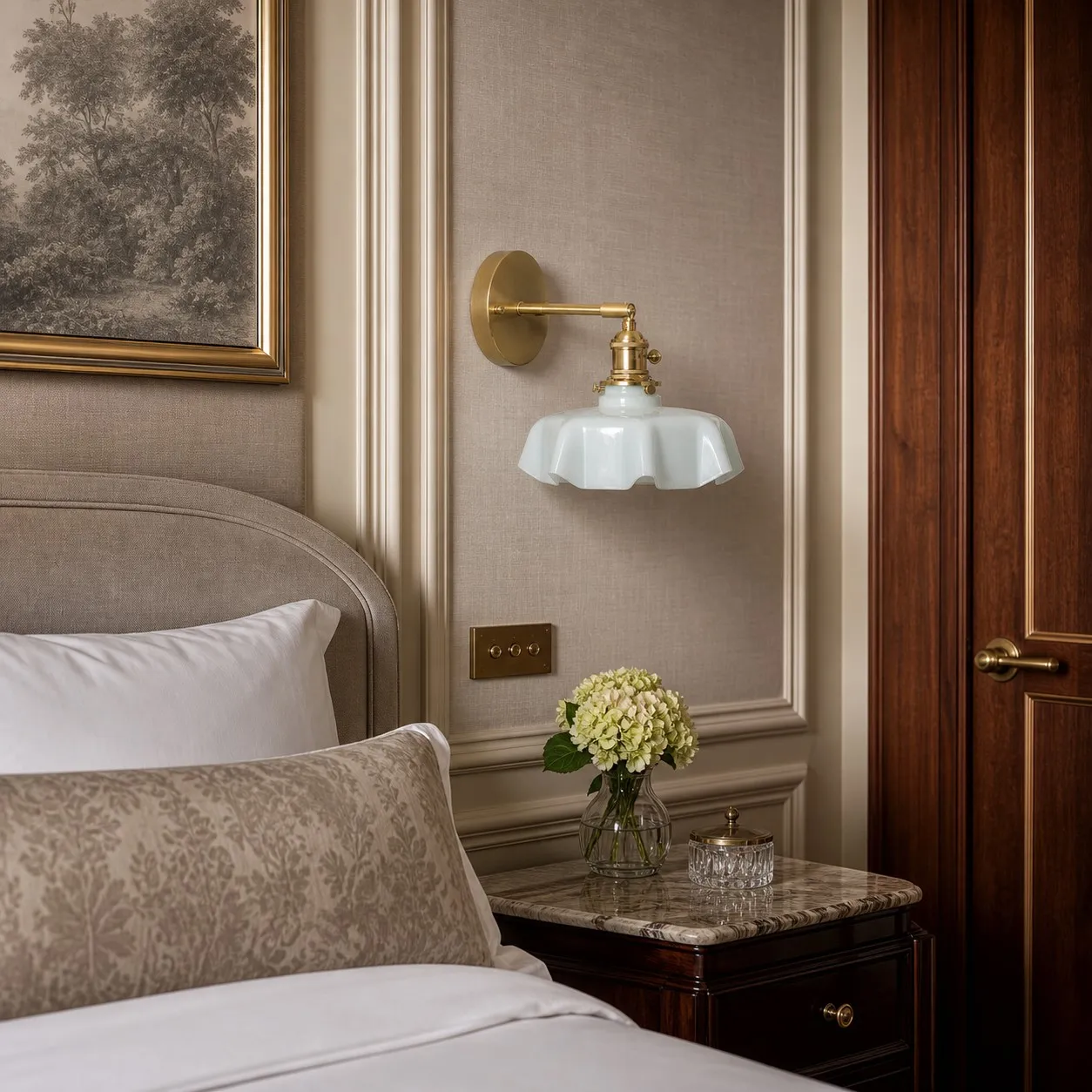 Blue milk glass brass wall sconce beside a bed