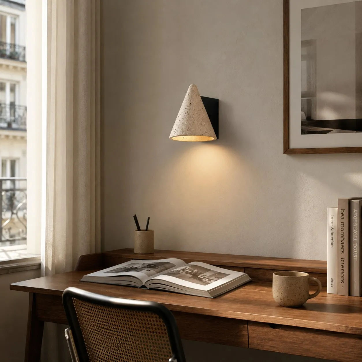 Desk corner scene with warm travertine wall light