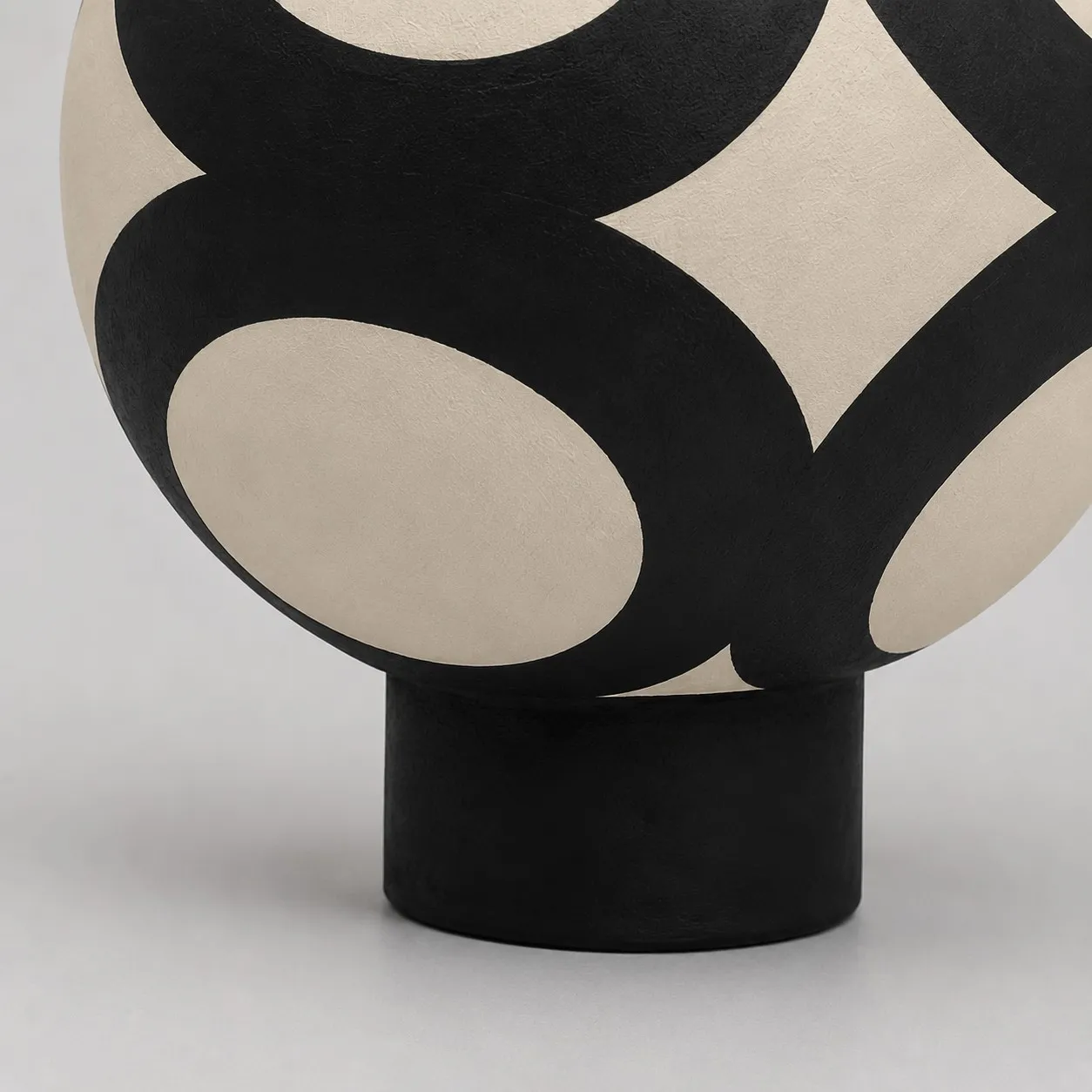 round ceramic body and black base detail