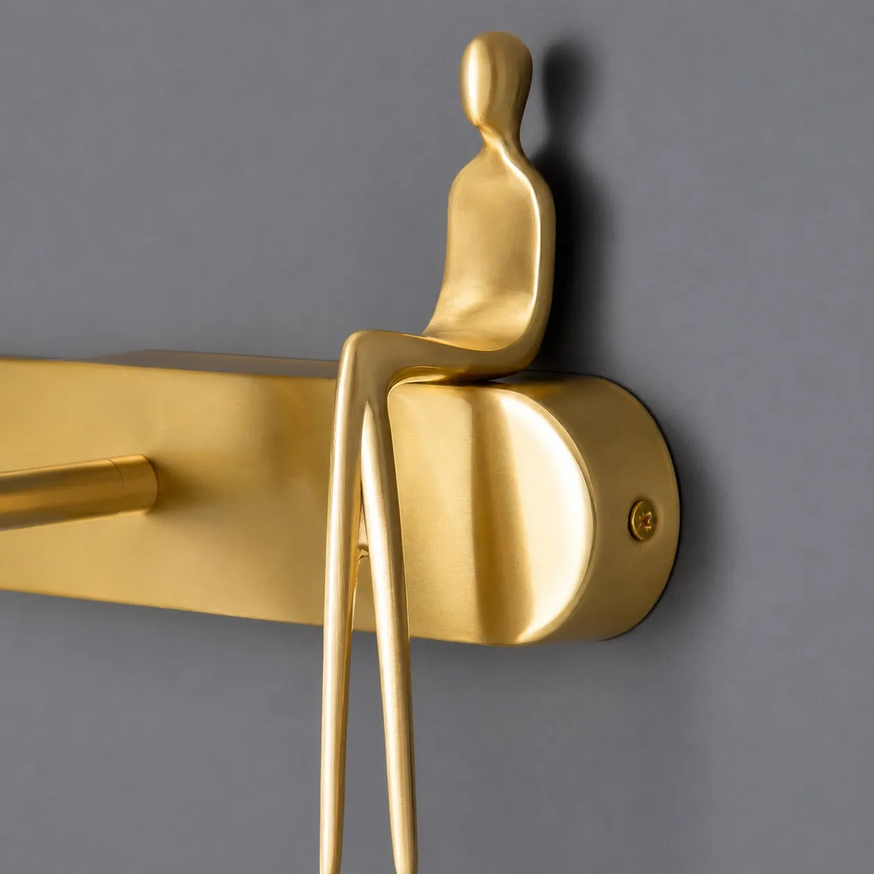 Brass wall plate with decorative figure