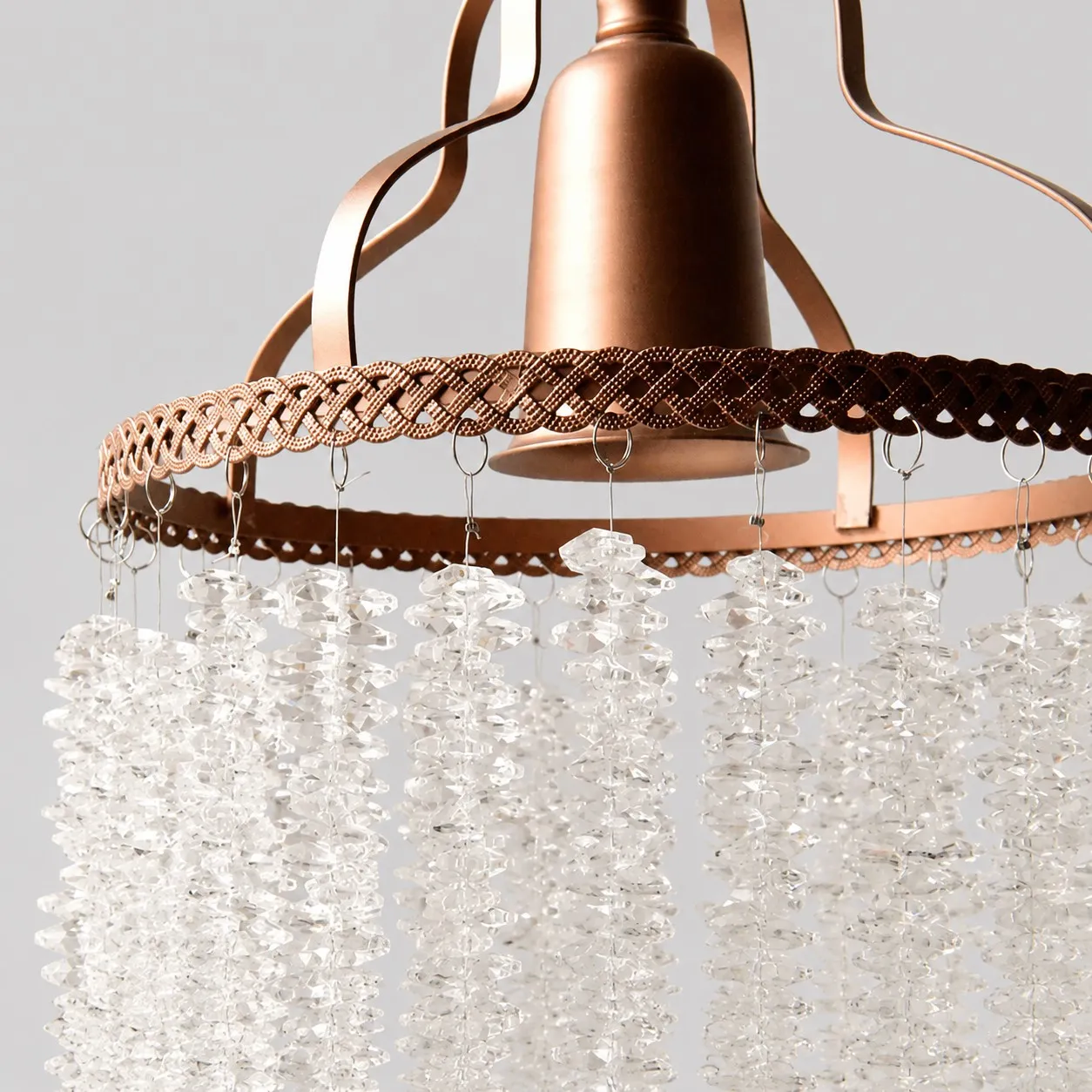 Close view of the woven metal rim and crystal strand attachments