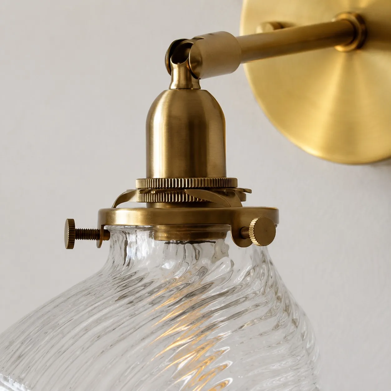 Clear ribbed glass shade and brass holder detail