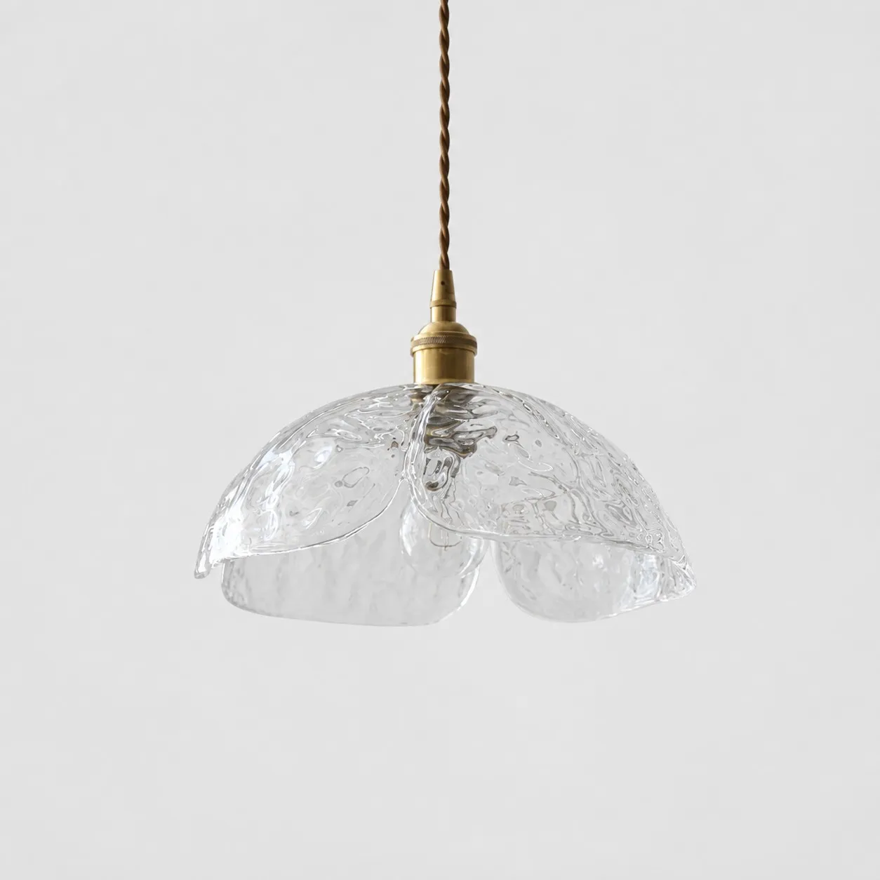 Single clear pressed-glass flower pendant with brass socket