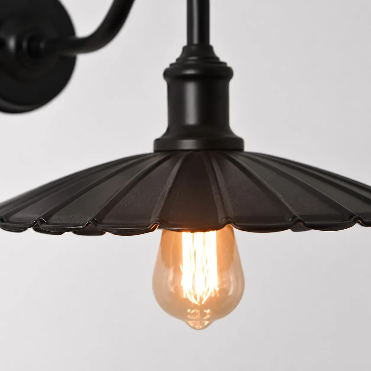 Antique Bronze wall sconce shade and arm detail