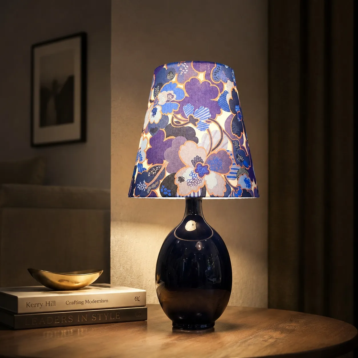 Blue floral fabric ceramic table lamp on a bedside table