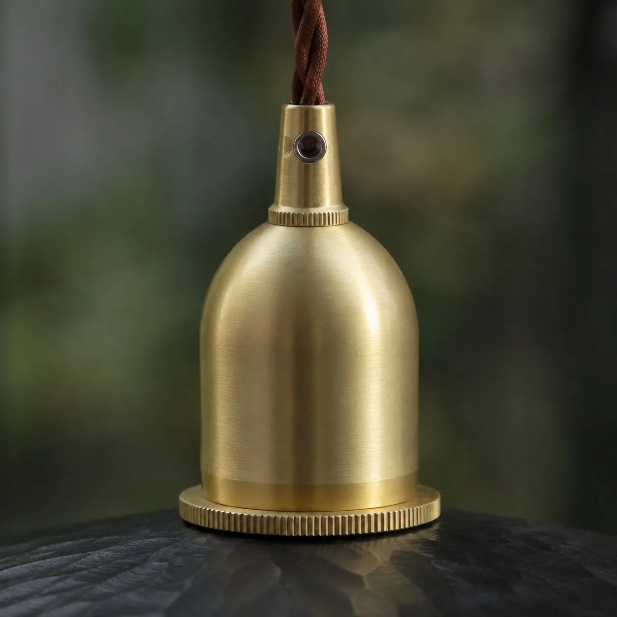Brass tone holder detail on octagonal wood pendant light
