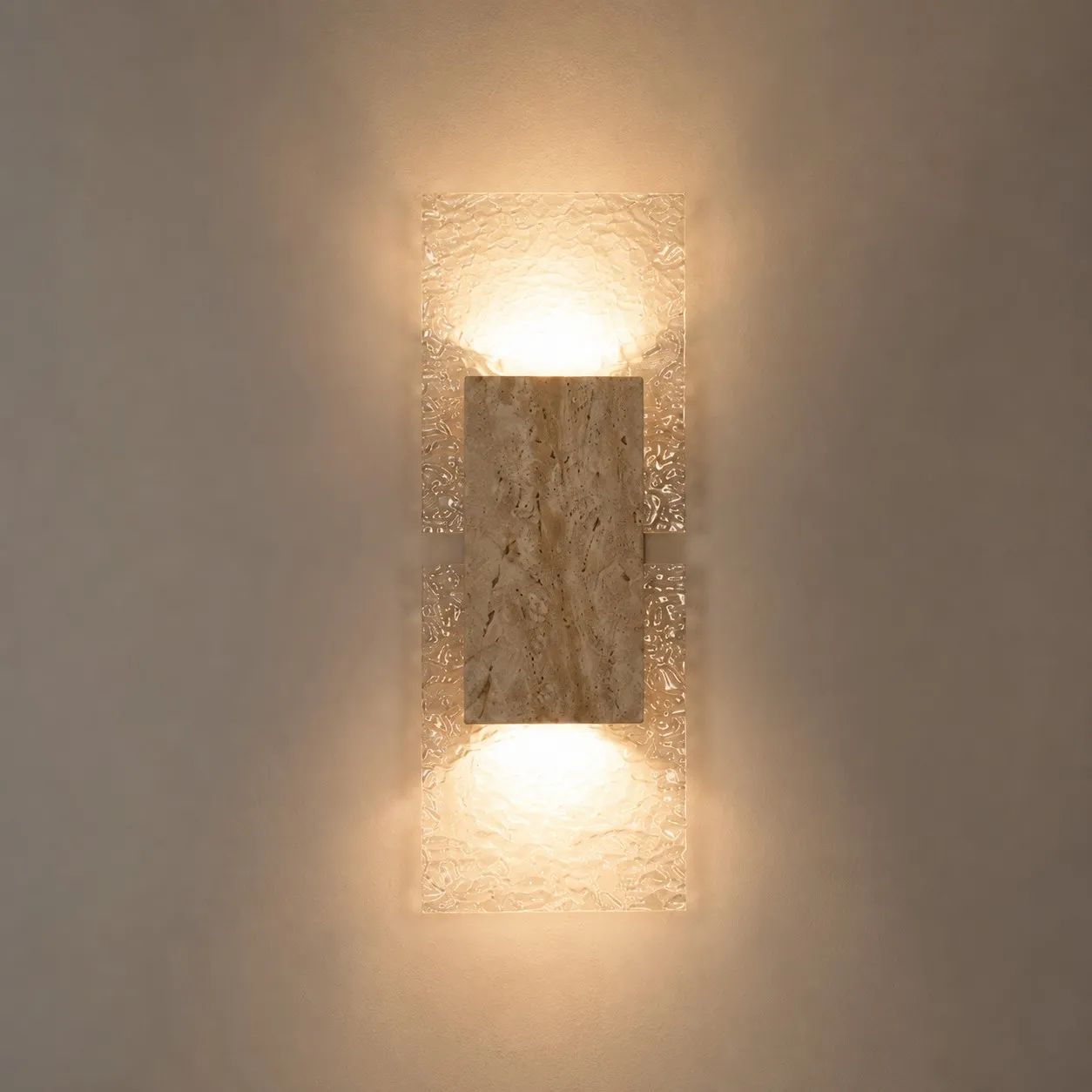 Up and down warm wash light on travertine acrylic sconce
