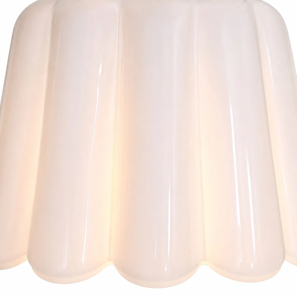 Close view of white scalloped ceramic shade