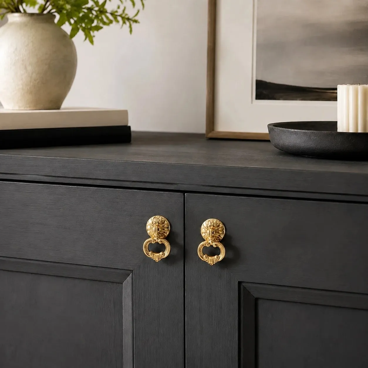 Brass ring pulls on a dark cabinet